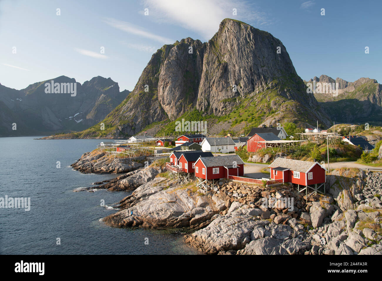 The old fishing village of Hamnoy where the rorbu (fishermen’s huts) are now used for tourist accommodation backed by Festhelltinden Mountain.  Lofote Stock Photo