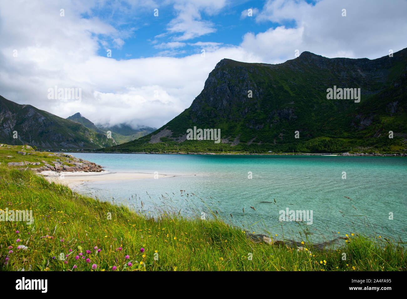 Aqua coloured water in Flakstadpollen, a sea bay surrounded by mountains, Flakstadoy, Lofoten Islands, Norway Stock Photo
