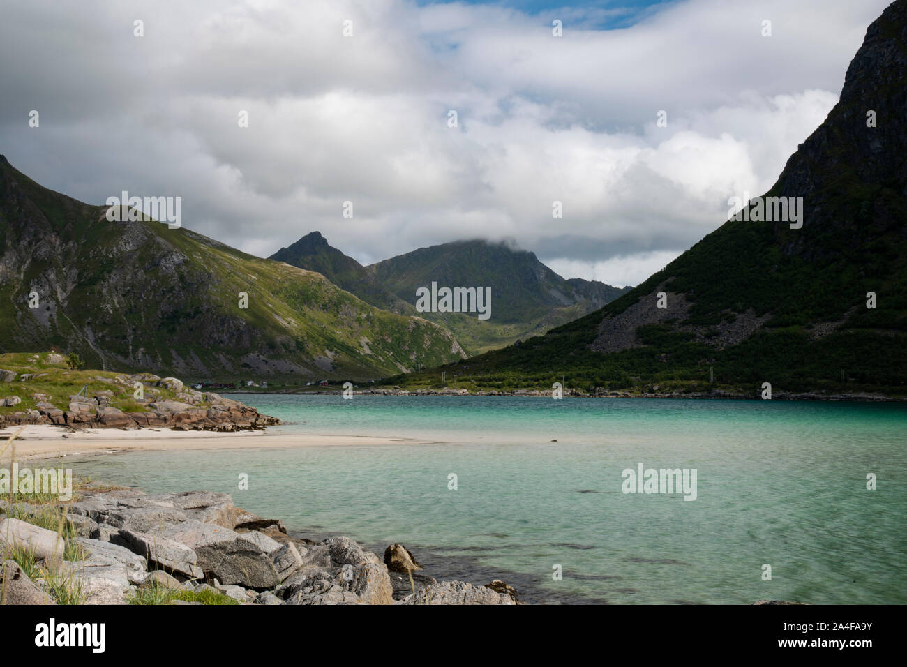 Aqua coloured water in Flakstadpollen, a sea bay surrounded by mountains, Flakstadoy, Lofoten Islands, Norway Stock Photo