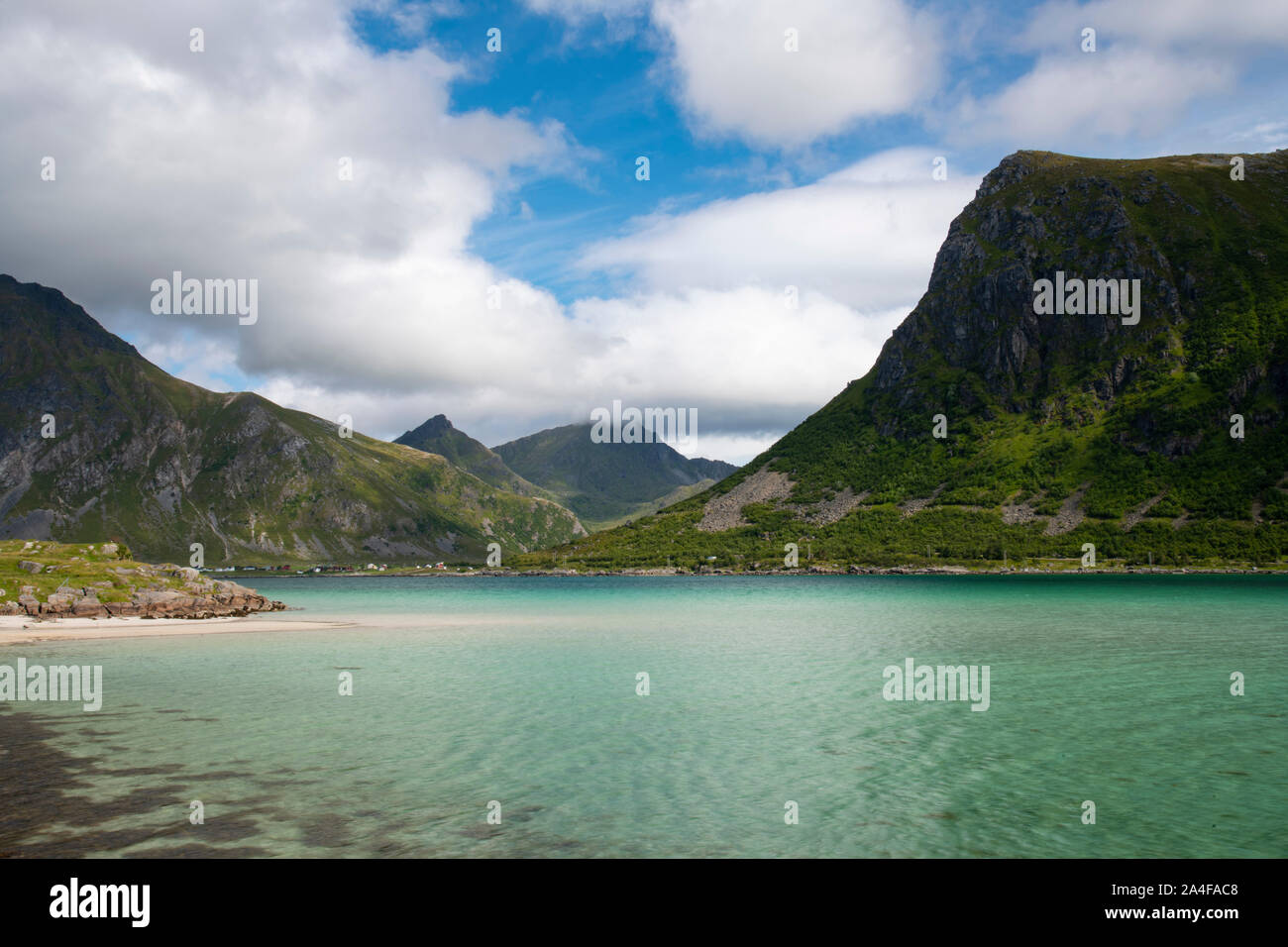 Aqua coloured water in Flakstadpollen, a sea bay surrounded by mountains, Flakstadoy, Lofoten Islands, Norway Stock Photo