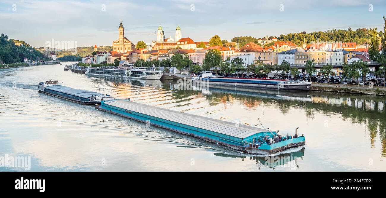 Container ship drives through Passau harbor Stock Photo