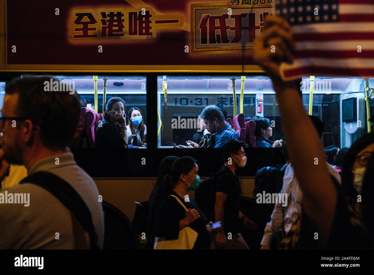 Hong Kong. 14th Oct, 2019. Daily commuters get stuck in the traffic during the Hong Kong Human Rights and Democracy Act Rally at Chater Garden in Central District Hong Kong. This rally was proposed to US lawmakers that they should pass the act that would help the Hong Kong democracy. ItÃs aimed at putting pressure on Beijing to uphold its promise to preserve Hong KongÃs autonomy. Credit: Keith Tsuji/ZUMA Wire/Alamy Live News Stock Photo