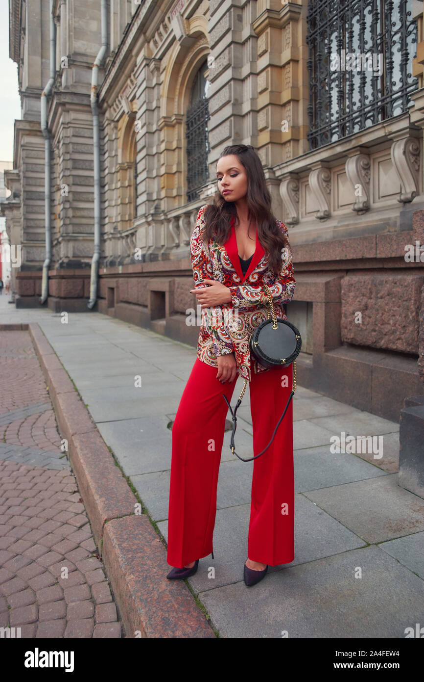 Woman in colorful red suit Stock Photo - Alamy