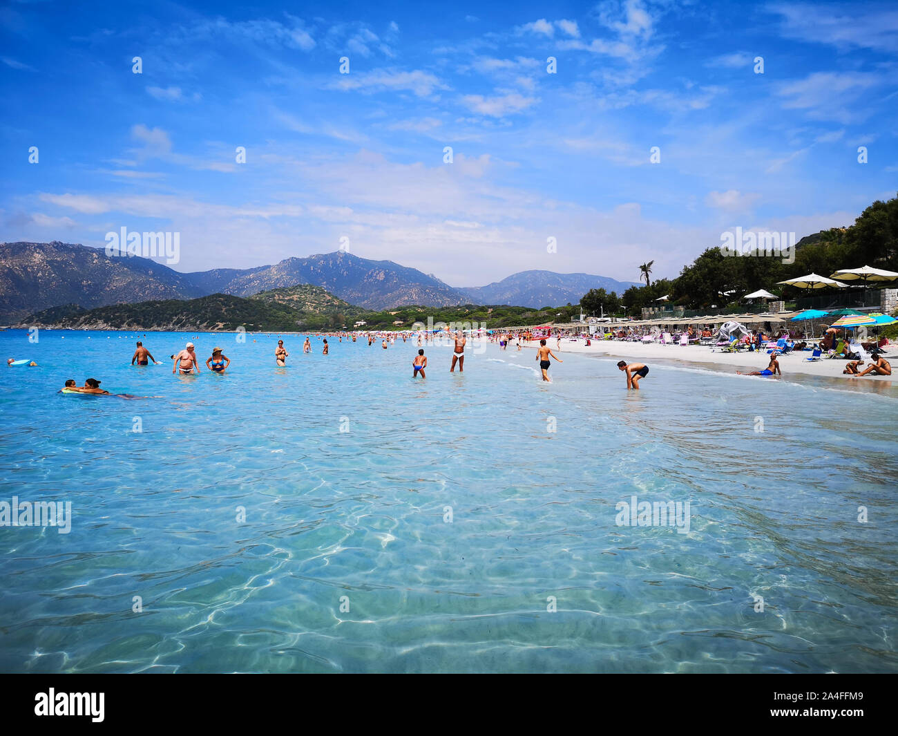 Villasimius, Italy - August 8, 2019: Blue and transparent water and the light sand of a beach in Sardinia. Stock Photo