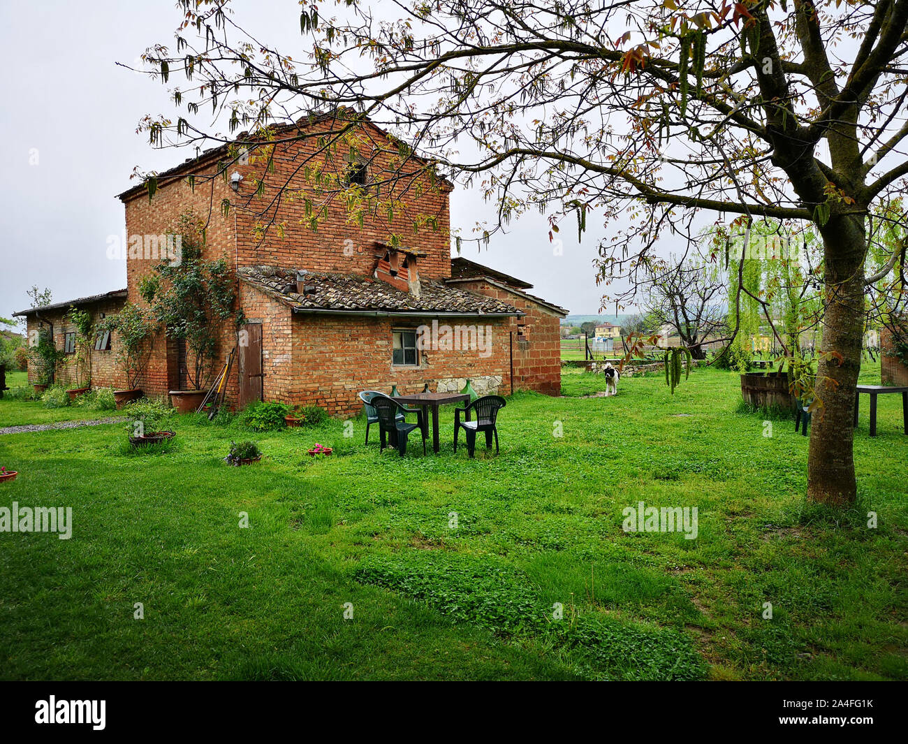 Old red brick cottage in the Italian countryside. Stock Photo