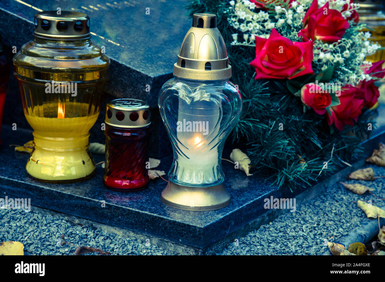 burning candles in lanterns in cemetery Stock Photo Alamy