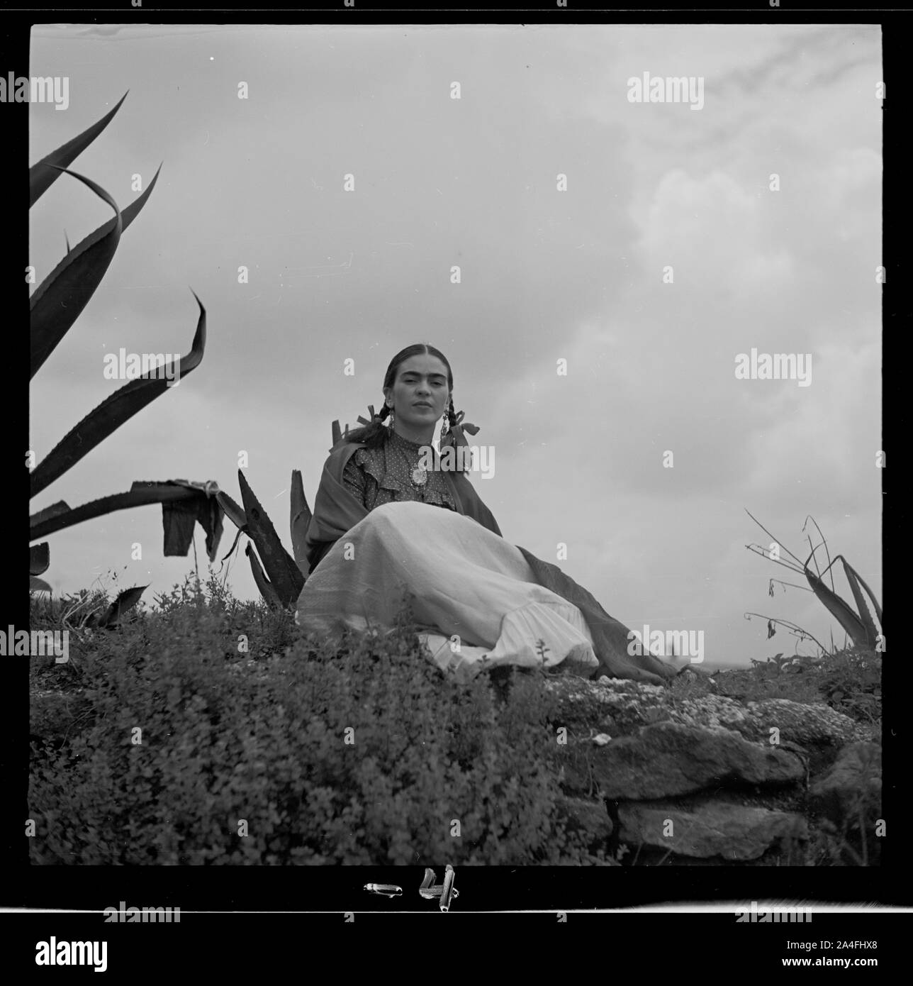 Frida Kahlo, seated next to an agave plant, from a 1937 photo shoot for  Vogue entitled Seoras of Mexico Stock Photo - Alamy