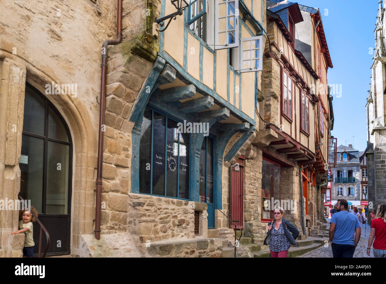 Tourists walking in street with 16th century timber framed / half timbered houses in the old town of the city Vannes, Morbihan, Brittany, France Stock Photo