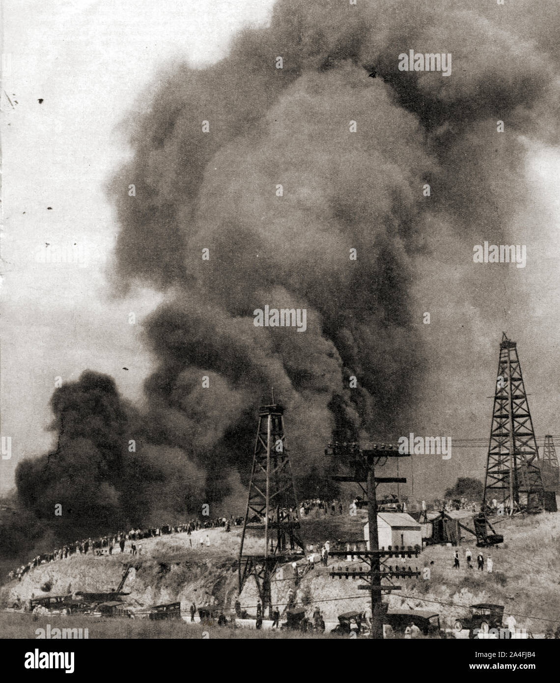A photograph of a large fire that took place at  a Los Angeles oil rig fire in the 1930's .By 1930, California was producing nearly  a quarter of the world's oil , and the towns population had grown to 1.2 million Stock Photo