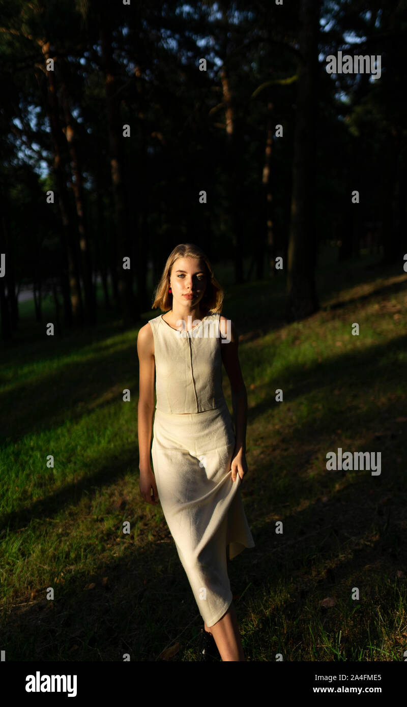 young woman standing in a rural forest Stock Photo