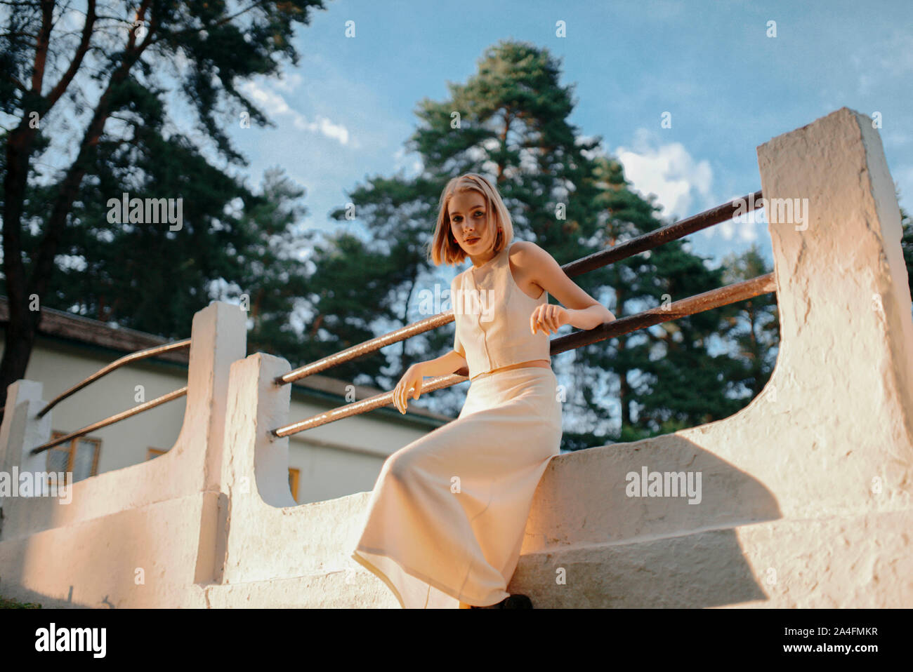 woman sitting near the fence in the park Stock Photo