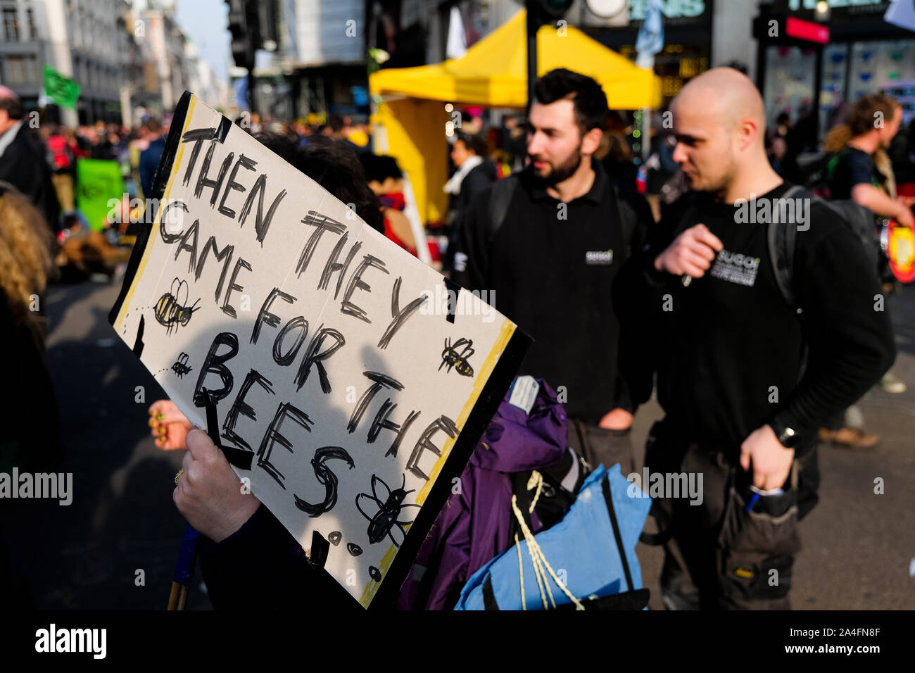 London, UK. A protester holds a sign at Oxford Circus as London comes to a standstill as protesters with the Extinction Rebellion protest crowd the st Stock Photo
