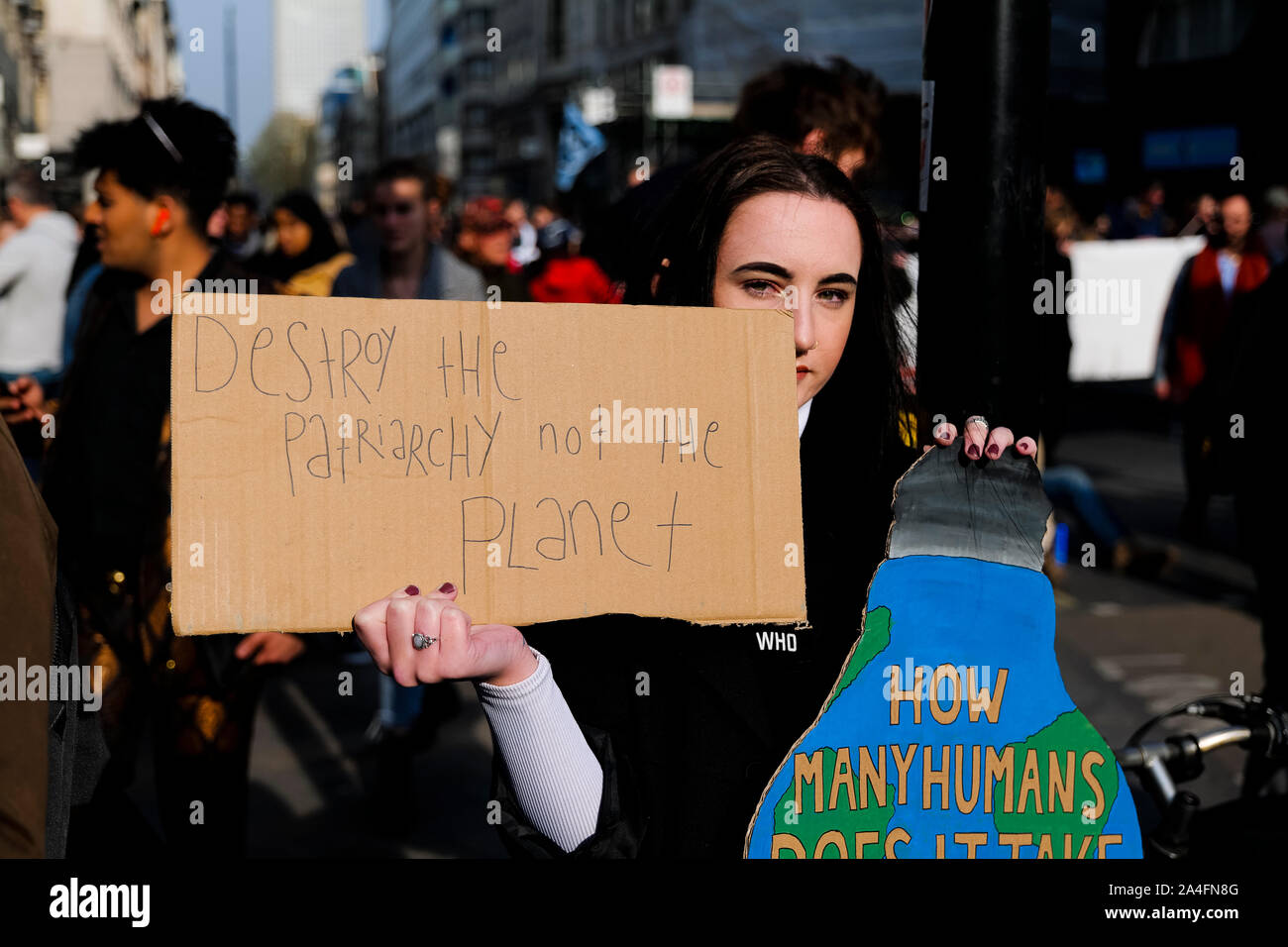 London, UK. A protester holds a handwritten placard at the  Extinction Rebellion protest at Oxford Circus. Stock Photo