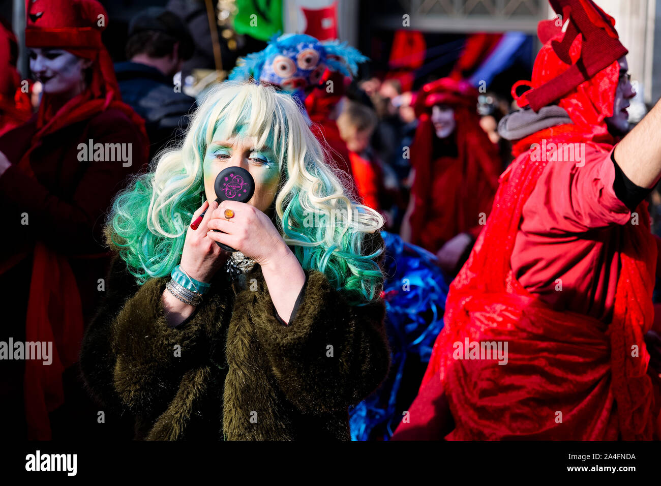 London, UK. A protester applies makeup at Oxford Circus as London comes to a standstill as protesters with the Extinction Rebellion protest crowd the Stock Photo
