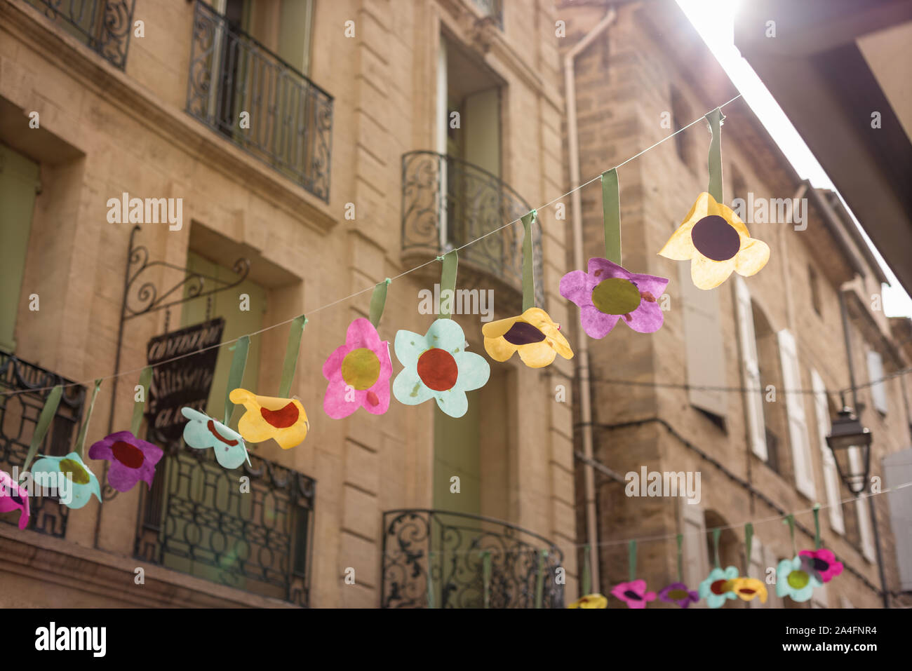 Hanging flower decorations in street in south of France Stock Photo