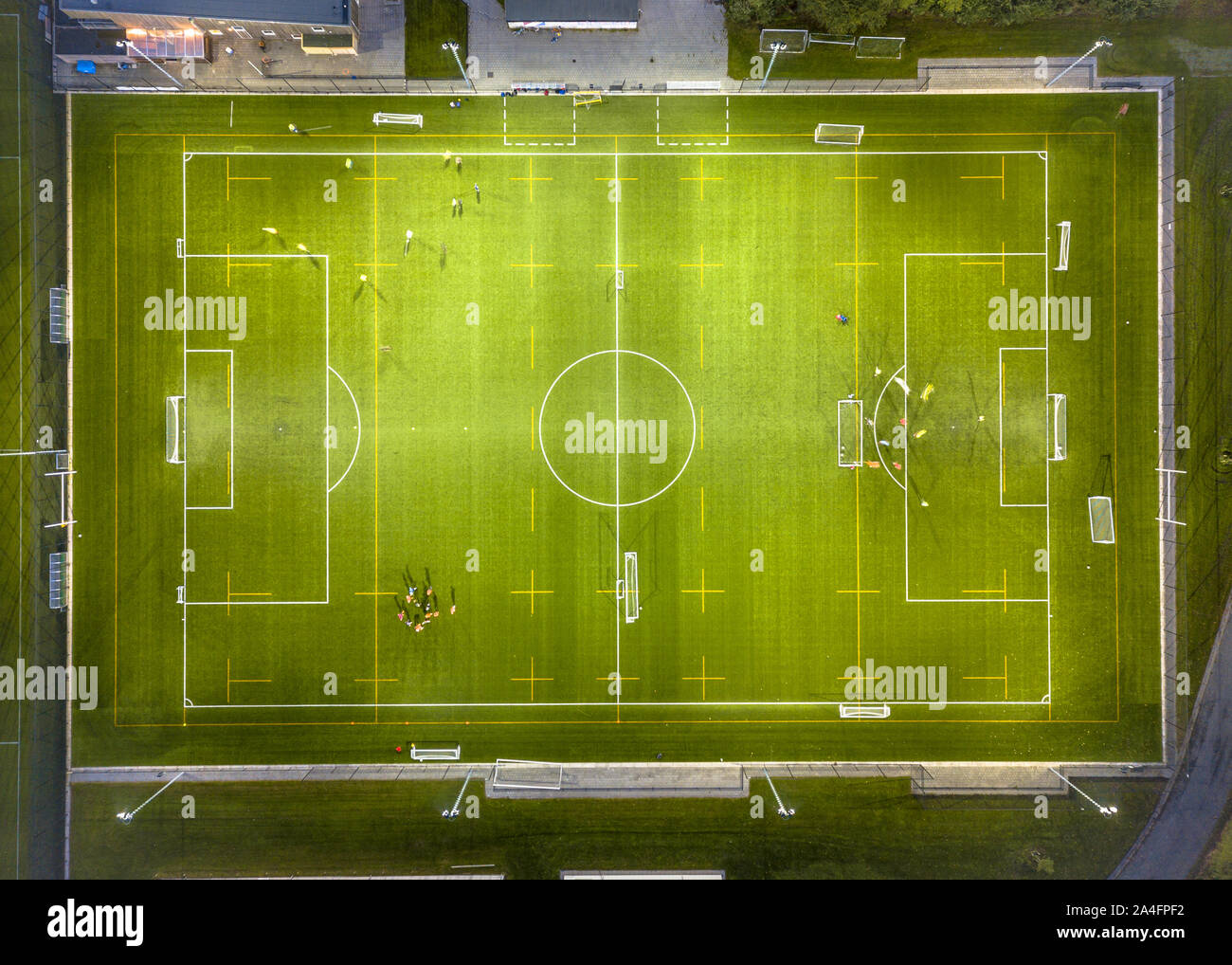 Aerial view of soccer field while athletes are training at night under