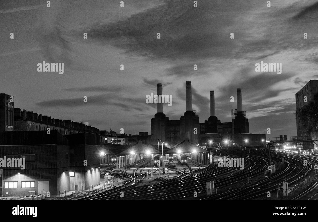 View from Ebury Bridge Pimlico looking south showing Battersea Power Station behind extensive railway sidings at night, City of Westminster. London, England, UK Stock Photo