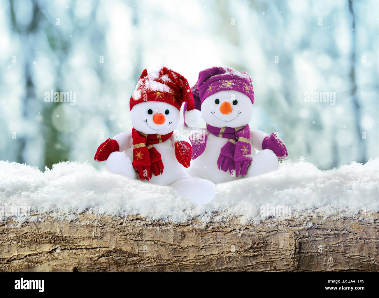 Merry christmas and happy new year greeting card .Two cheerful snowman standing in winter landscape in snow. Stock Photo