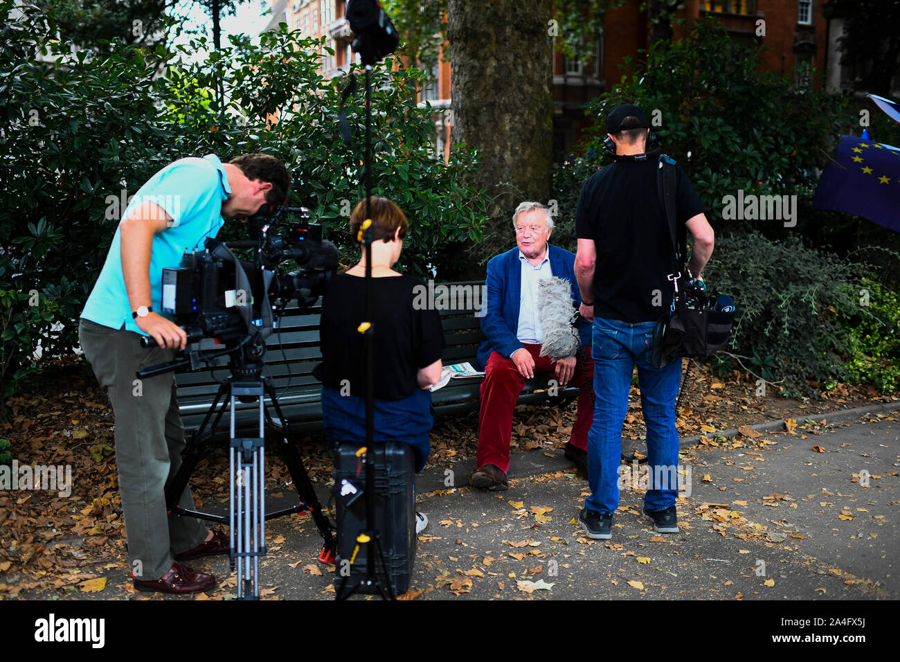 London, UK. Politician Ken Clarke gives an interview to a film crew in Victoria Tower Gardens near the Houses of Parliament. Stock Photo