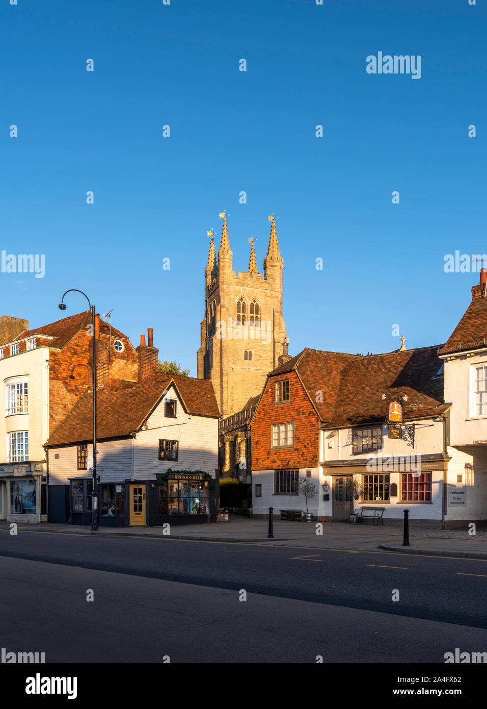 Tenterden High Street with St. Mildred's Church lit at sunrise, Kent. Stock Photo