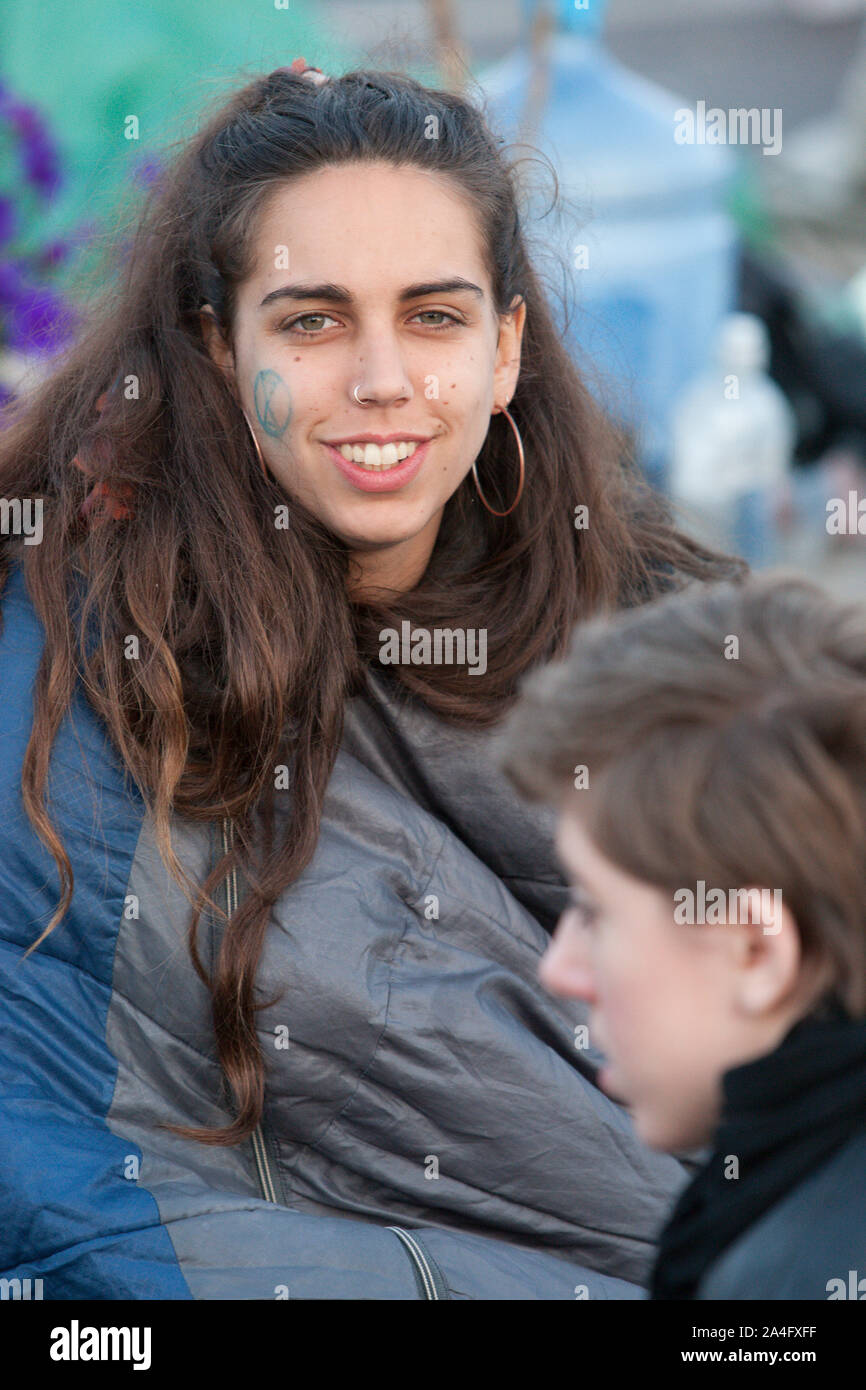 London, UK. A protester with the Extinction Rebellion logo drawn on her face on Waterloo Bridge. Stock Photo