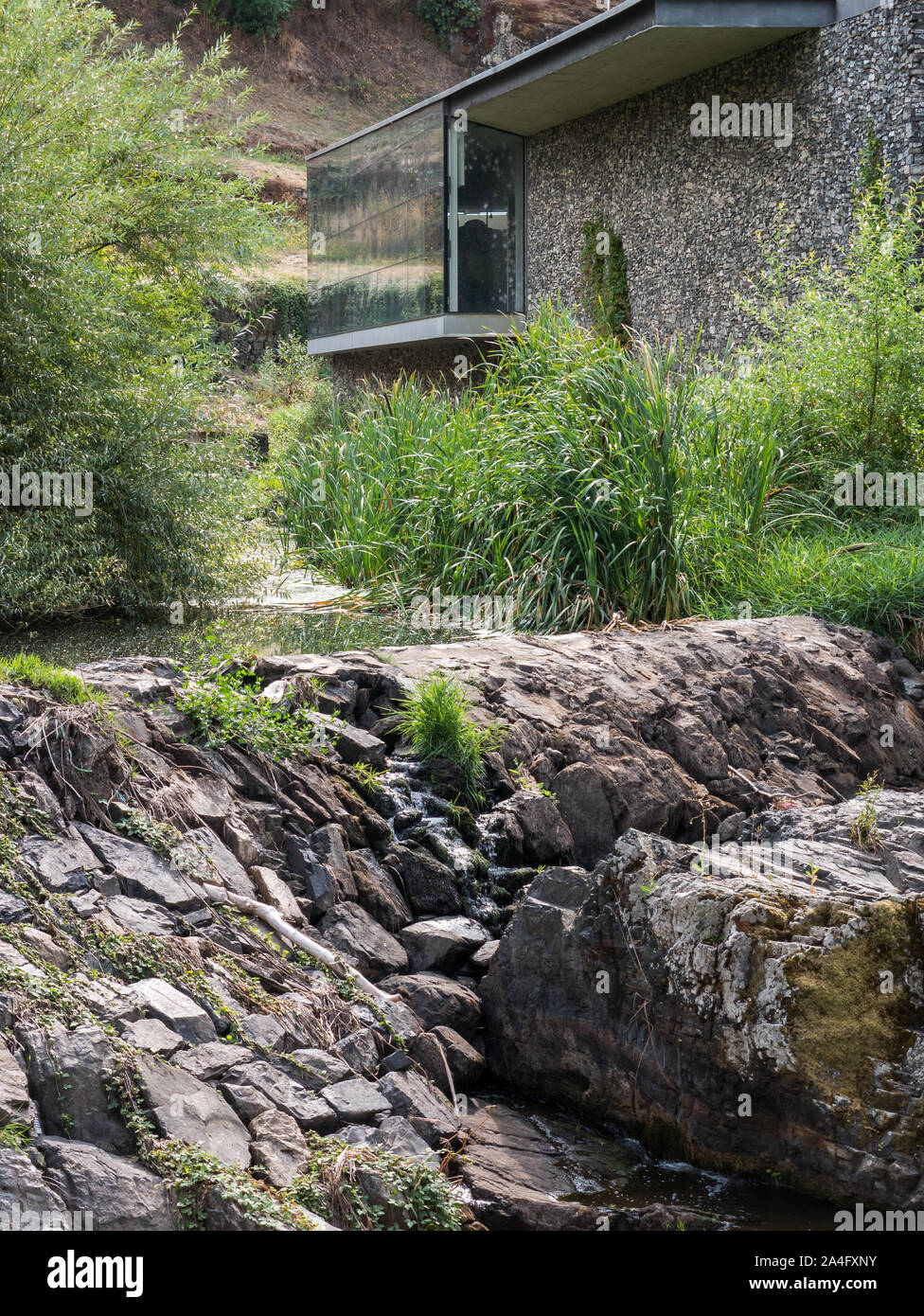 Side view of the Centro de Cienca Viva building (Live Science Center) at the River Fervenca in the Old Town of Bragança, Portugal Stock Photo