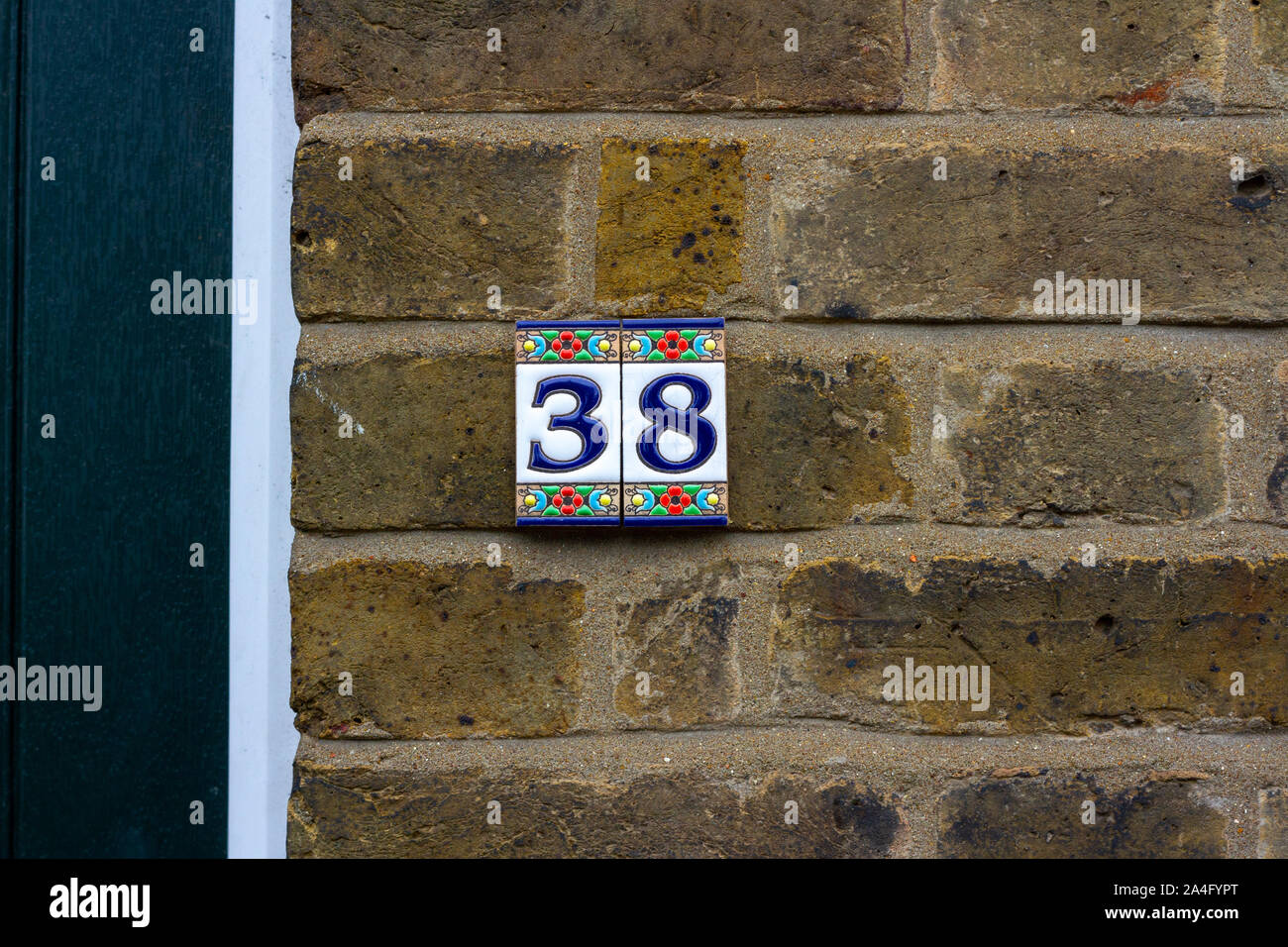 House number 38 in tile on a brick wall Stock Photo