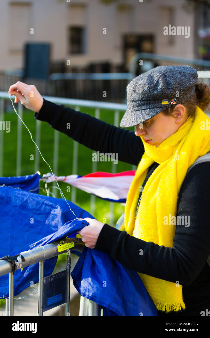 London, UK. A woman stitching an EU flag outside College Green in Westminster. Stock Photo