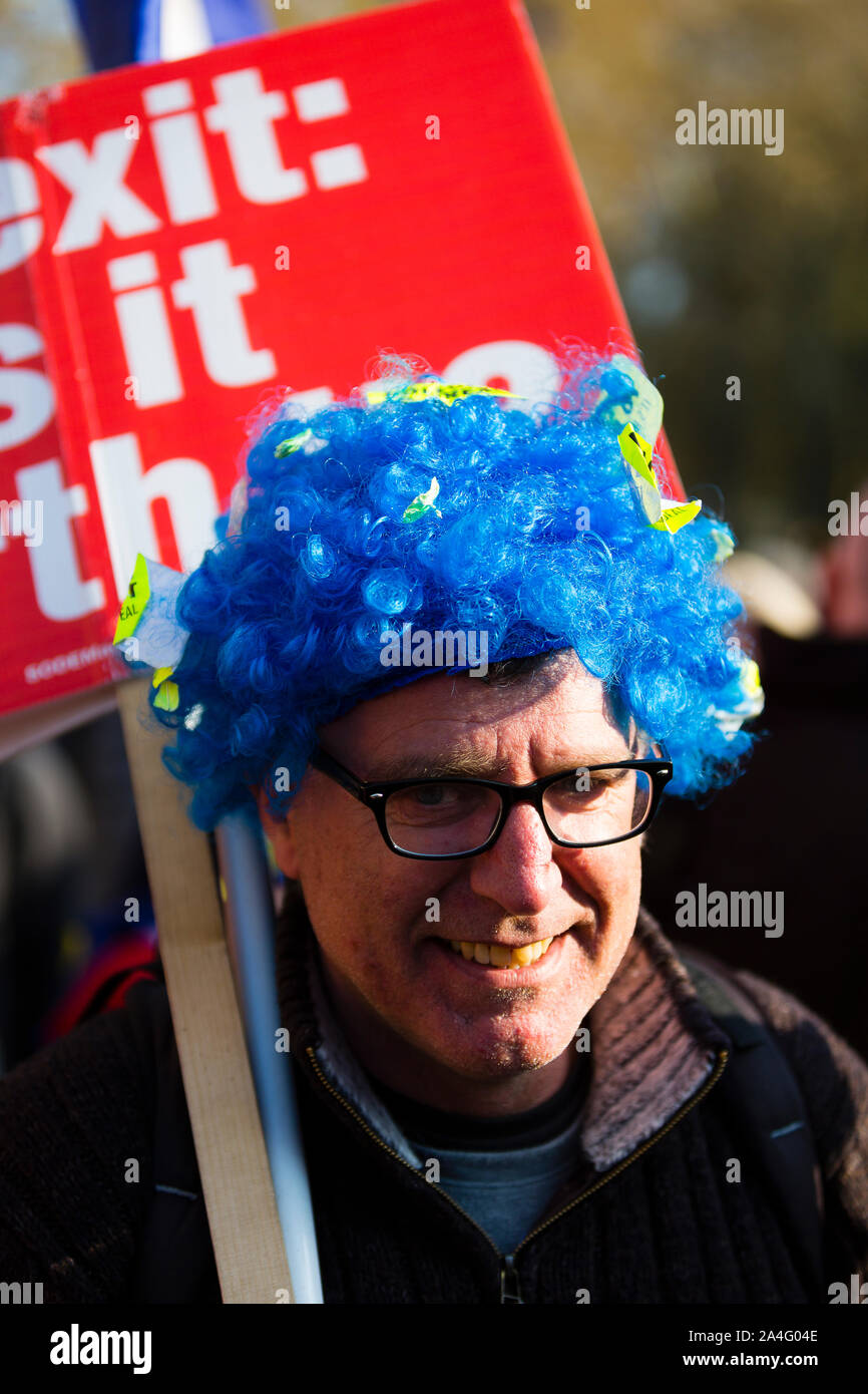 London, UK. A pro-EU protester wearing a bright blue wig outside the Houses of Parliament. Stock Photo