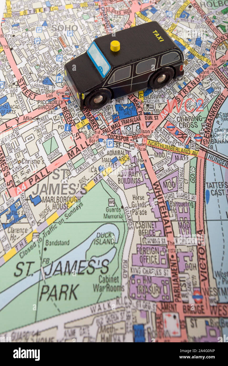 Toy taxi cab on map of west end of london, England Stock Photo