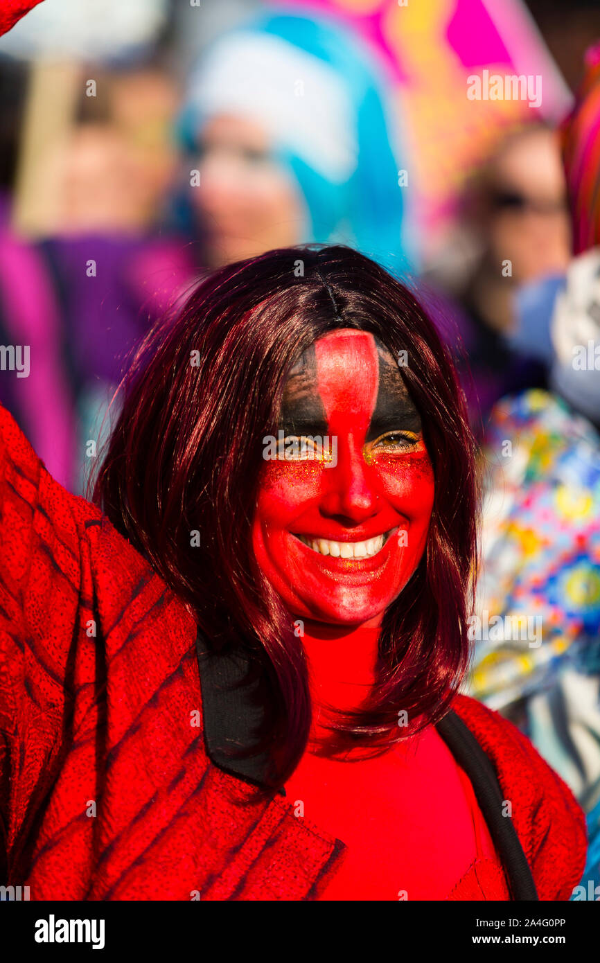 London, UK. A woman wearing bold red facepaint walks along Oxford Street during the Extinction Rebellion protest. Stock Photo