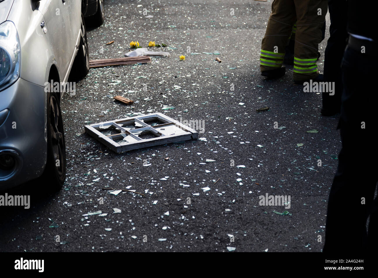 A window lies on the road surrounded by broken glass after being blown across the street in a large gas explosion on Foxley Gardens, a residential str Stock Photo
