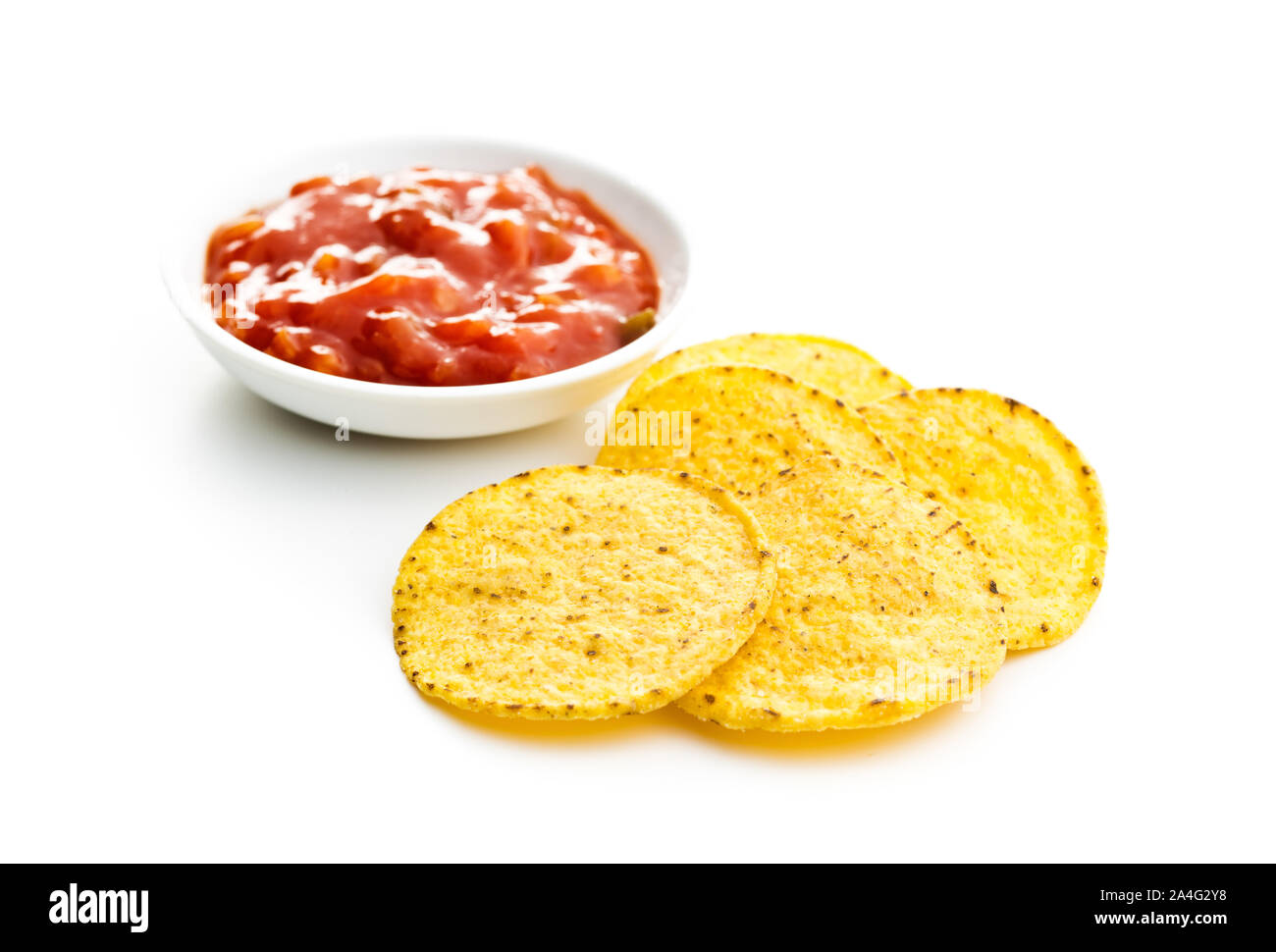 Round corn nacho chips and tomato dip. Yellow tortilla chips and salsa