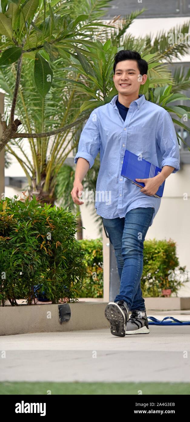 Smart Minority Boy Student Walking On Campus Stock Photo - Alamy