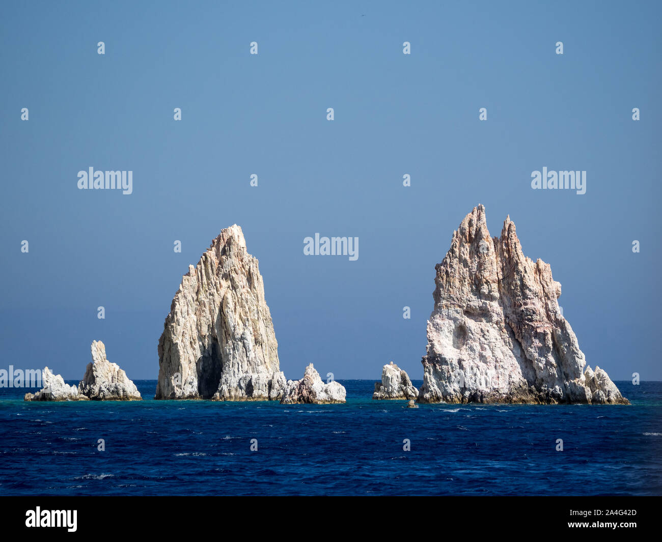 https://c8.alamy.com/comp/2A4G42D/a-view-of-poliegos-sharp-jaggered-teeth-needles-rocks-peloponnese-greece-in-calm-sea-water-under-clear-blue-sky-2A4G42D.jpg