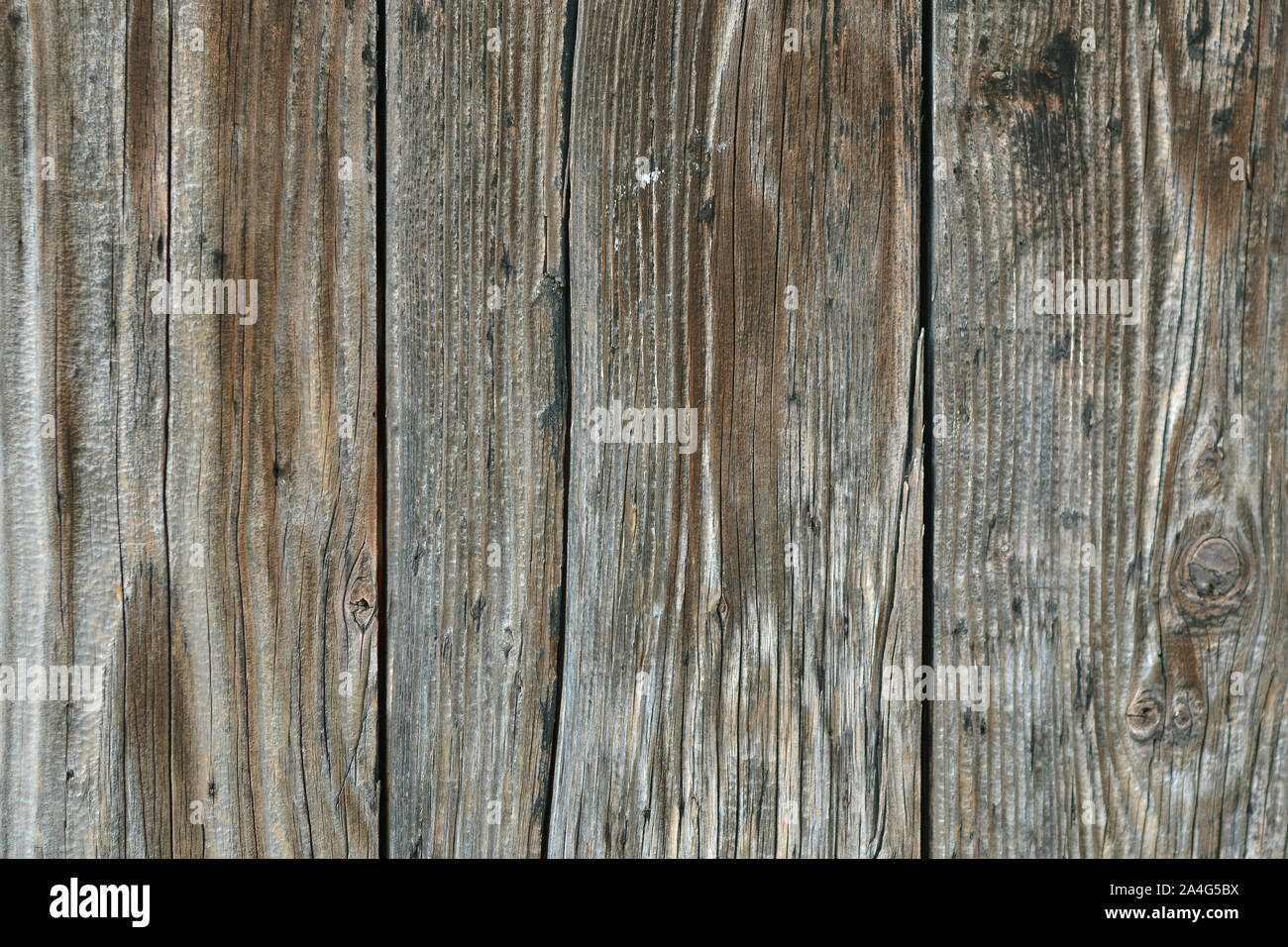 Fragment of the wall of old, weathered, gray with age boards. For use as an abstract background. Stock Photo