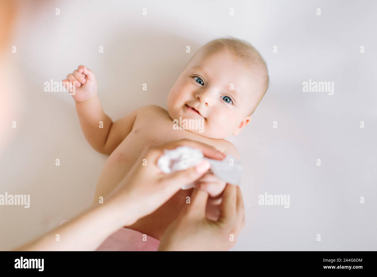 Mother Wiping Baby's hands Stock Photo Alamy