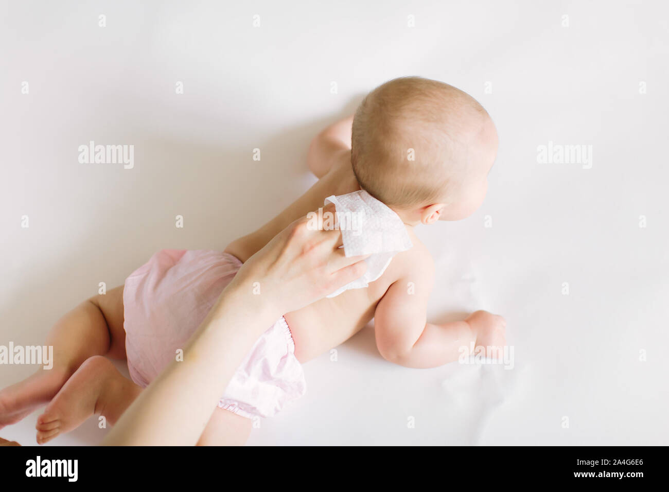 Mother Wiping Baby's back Stock Photo Alamy