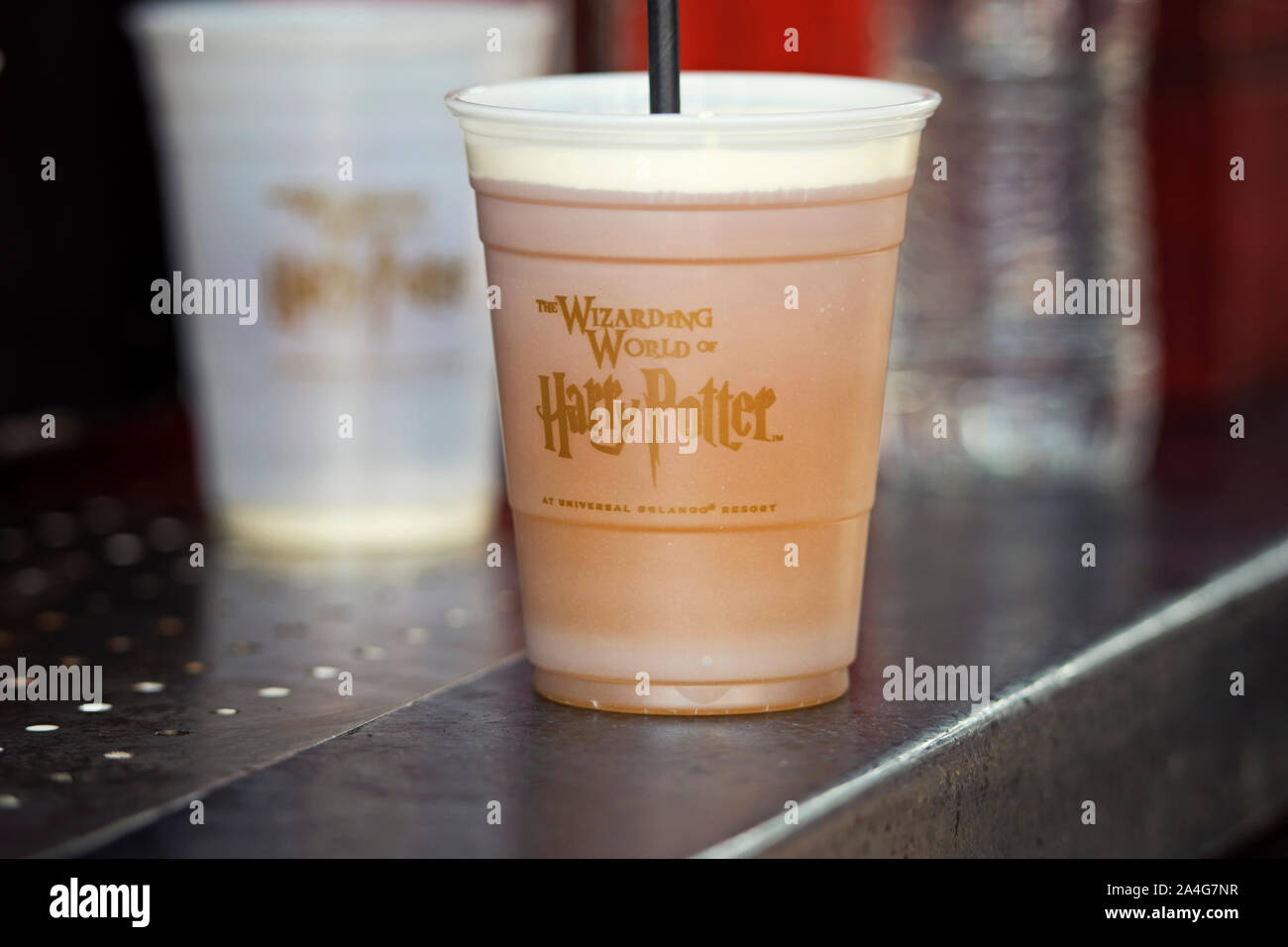 Butterbeer in a plastic cup, for sale at Hogsmeade, Islands of Adventure, Wizarding World of Harry Potter, Universal Studios, Orlando, Florida, USA Stock Photo