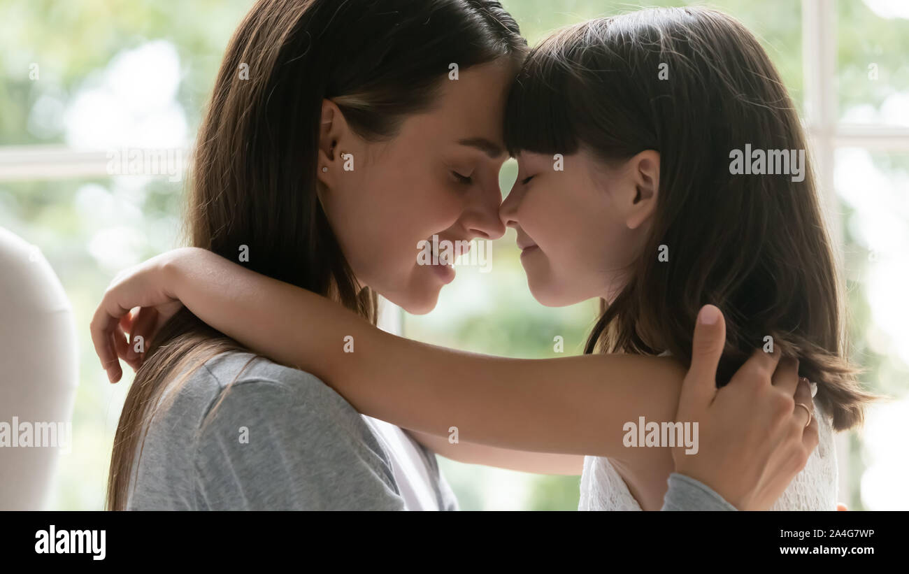 Happy bonding trustful female family of two touching noses. Stock Photo