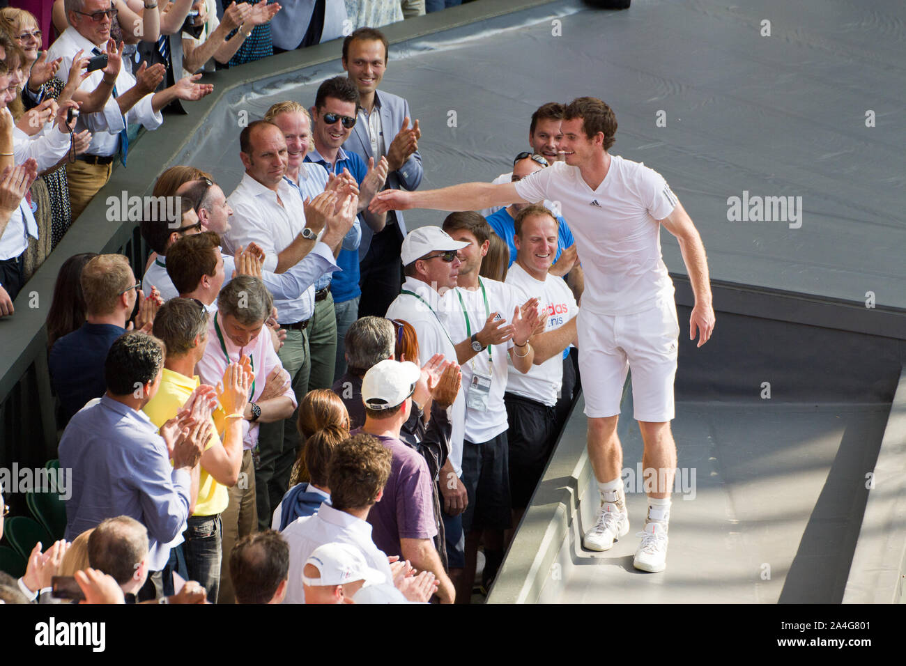 Andy Murray celebrates with his team after winning Wimbledon 2013. 77 years of tennis hurt comes to an end. Stock Photo