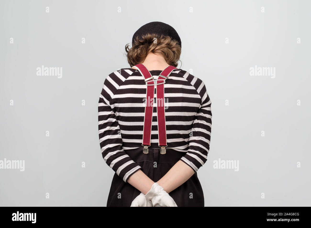 Sad young mime woman turning back being offended. Stock Photo