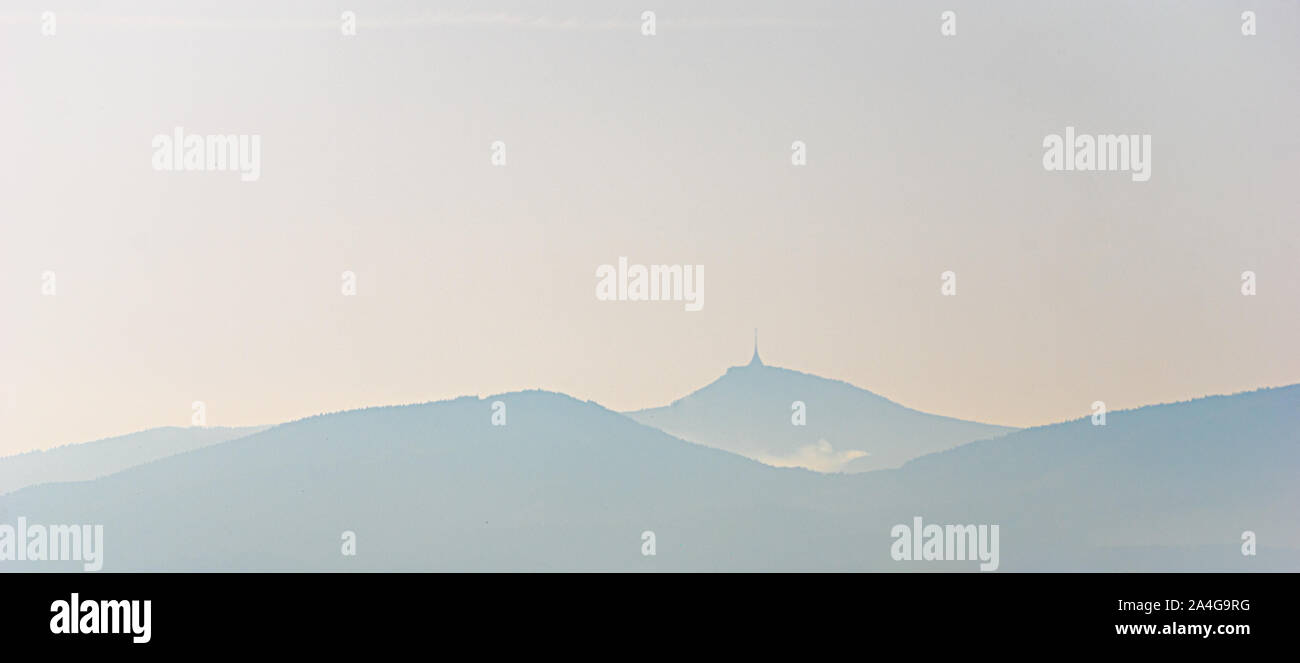scenic view on the silhouette of Mount Jested in hazy morning light Stock Photo