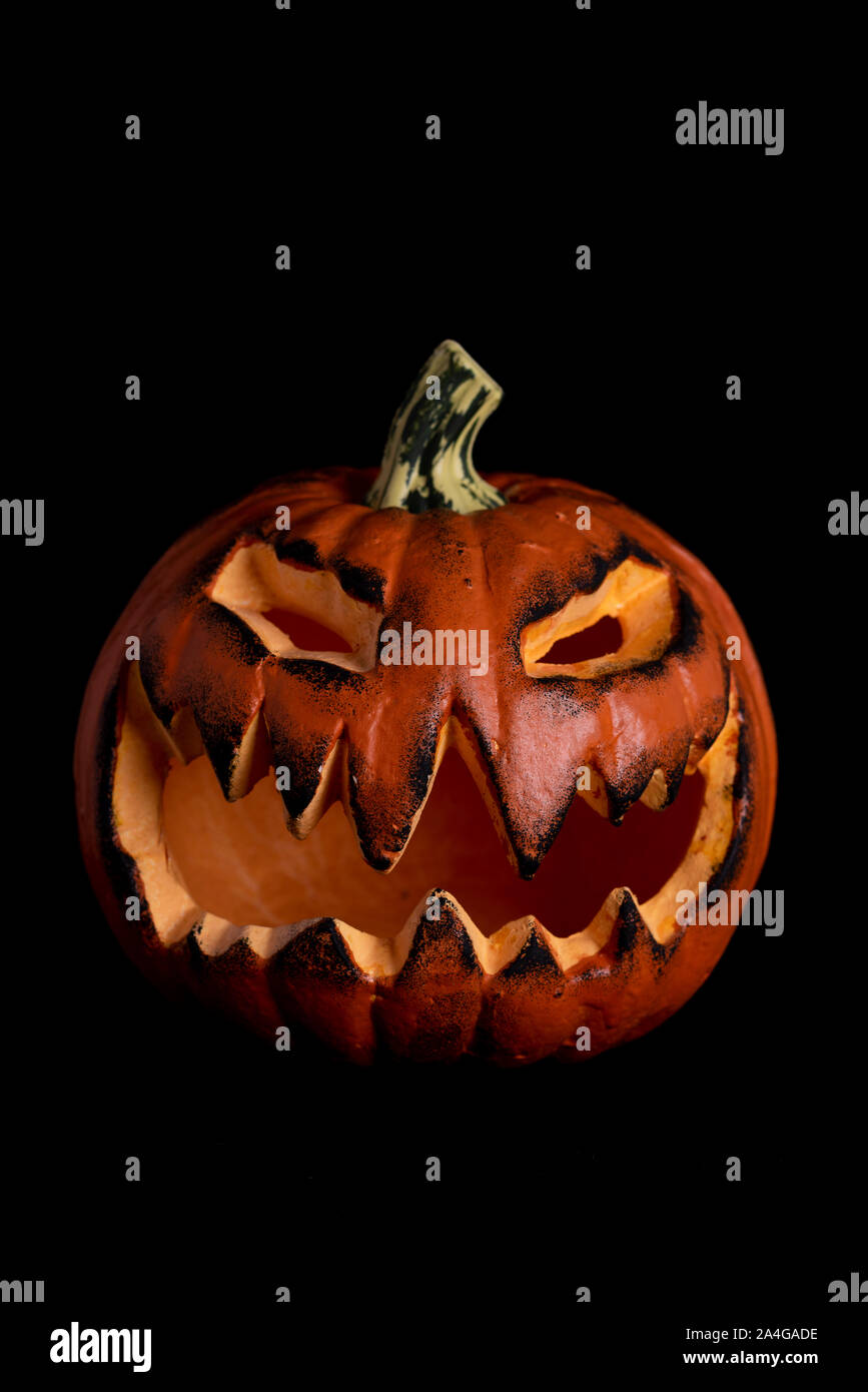 halloween pumpkin with scary face on black background Stock Photo - Alamy
