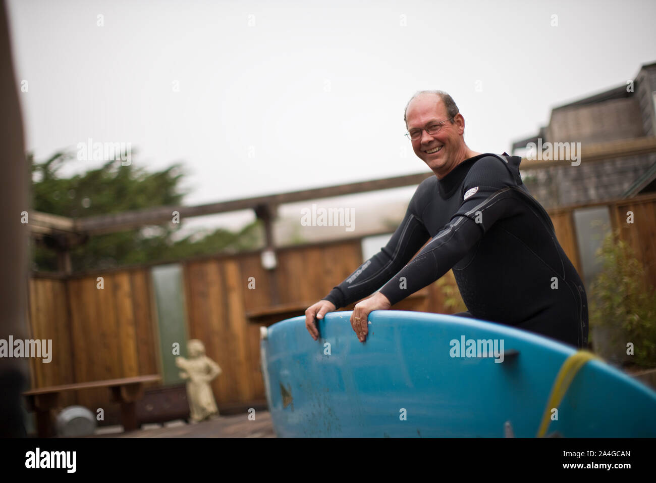 Smiling man wearing wetsuit hi-res stock photography and images - Alamy