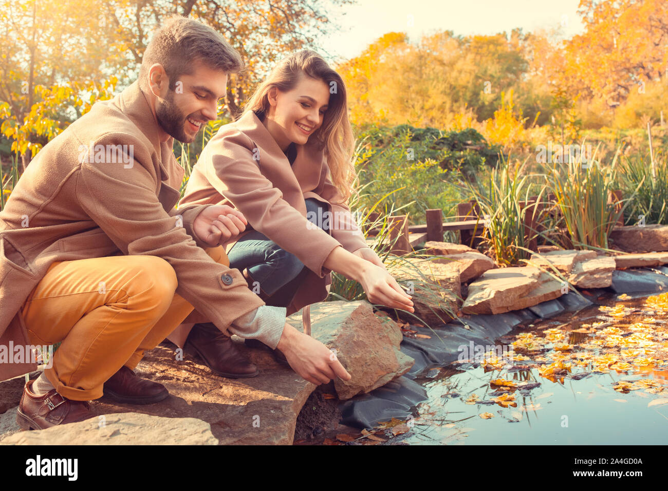 Young couple walk in the autumn park Stock Photo - Alamy