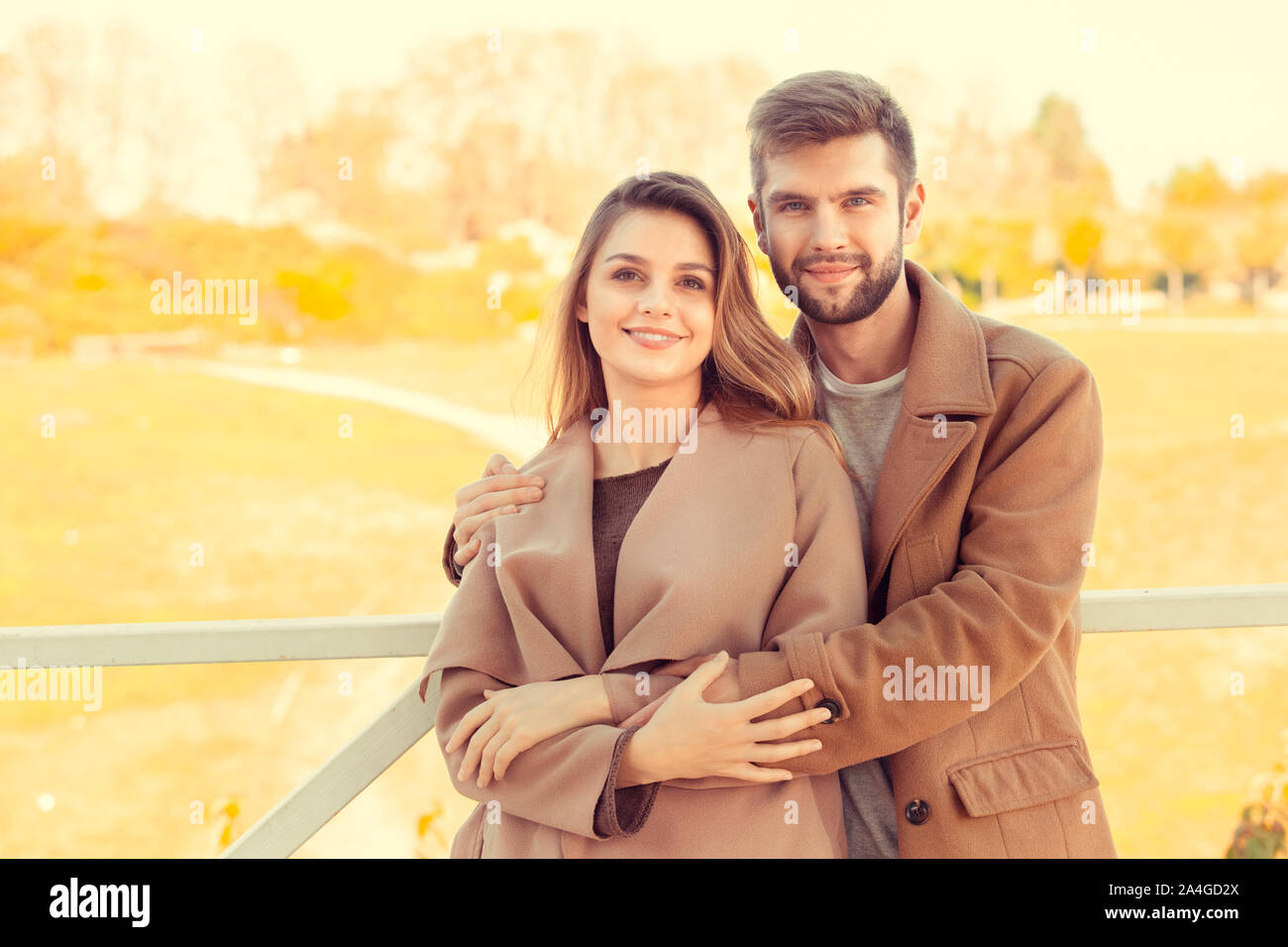 Young couple walk in the autumn park Stock Photo - Alamy