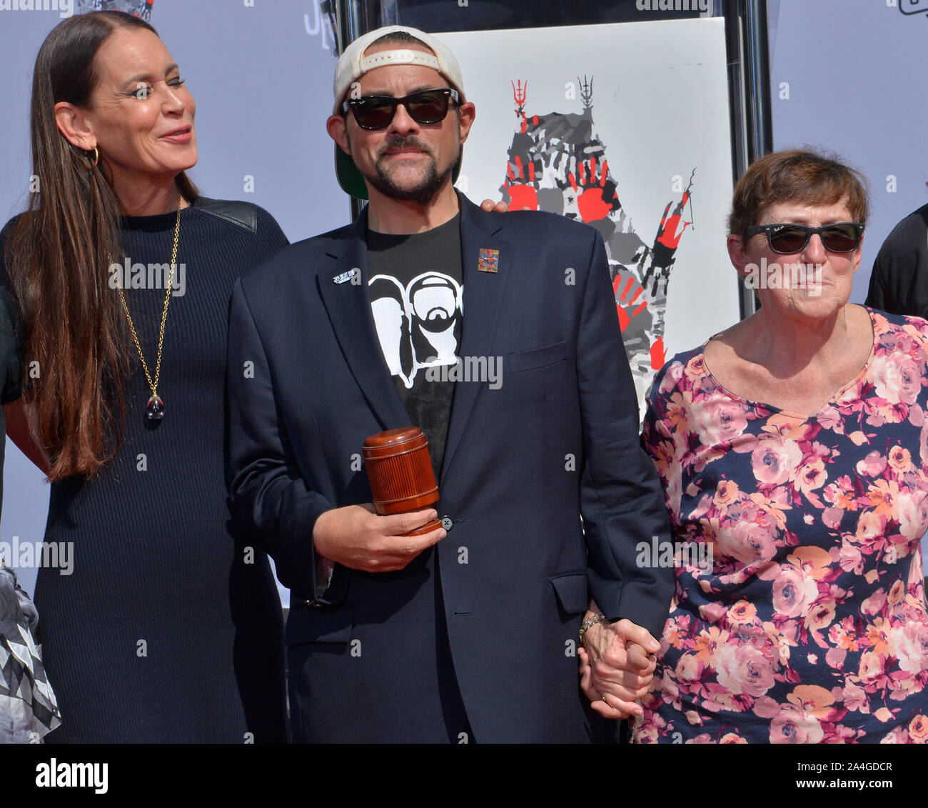 Los Angeles, United States. 14th Oct, 2019. Actor Kevin Smith (C) is joined by his wife Jennifer Schwalbach Smith (L) and his mother Grace (Shultz) during a hand and footprint ceremony immortalizing Kevin Smith and Jason Mewes in the forecourt of the TCL Chinese Theatre (formerly Grauman's) in the Hollywood section of Los Angeles on Monday October 14, 2019. Photo by Jim Ruymen/UPI Credit: UPI/Alamy Live News Stock Photo