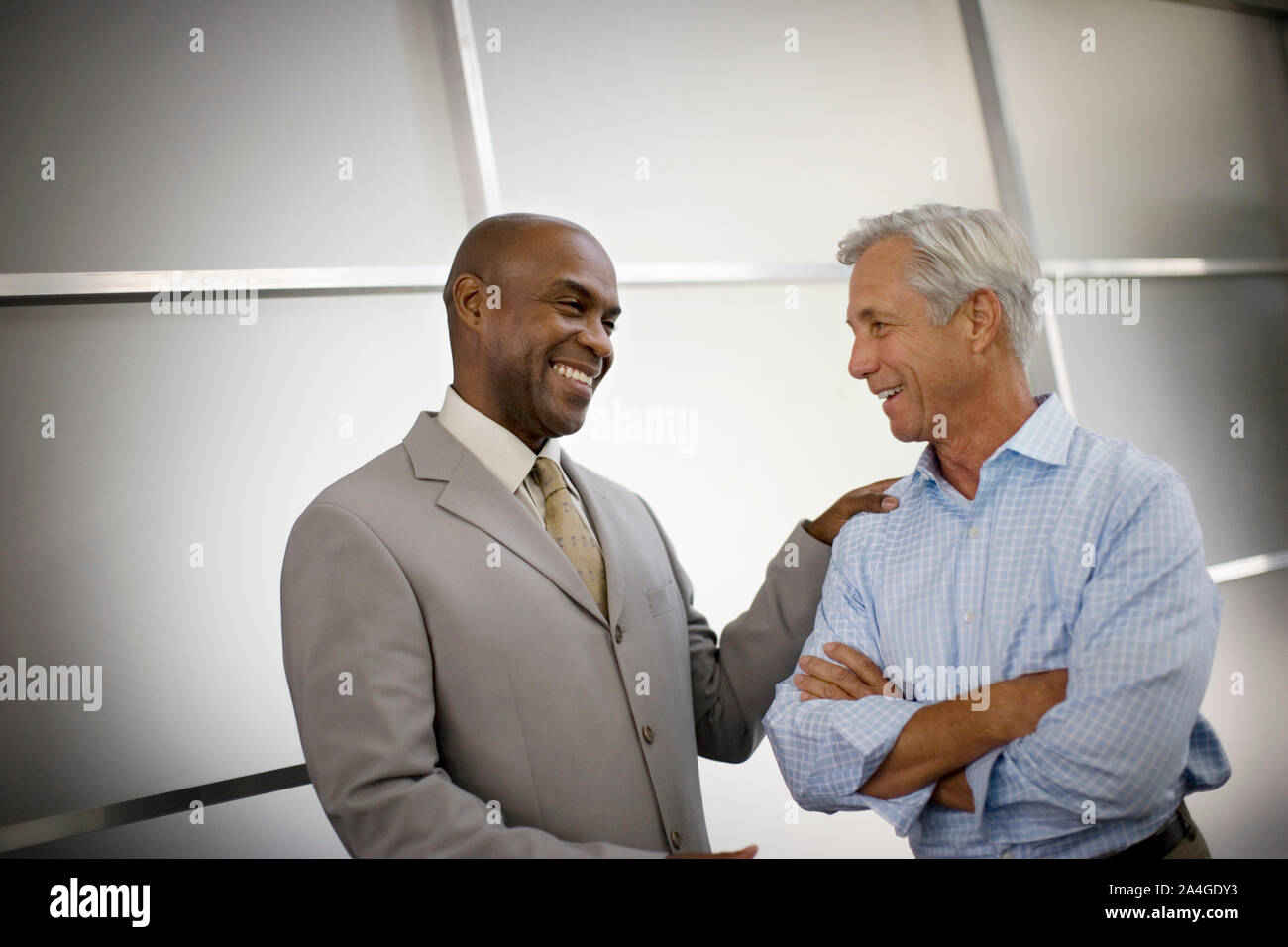 Two smiling businessmen having a discussion. Stock Photo