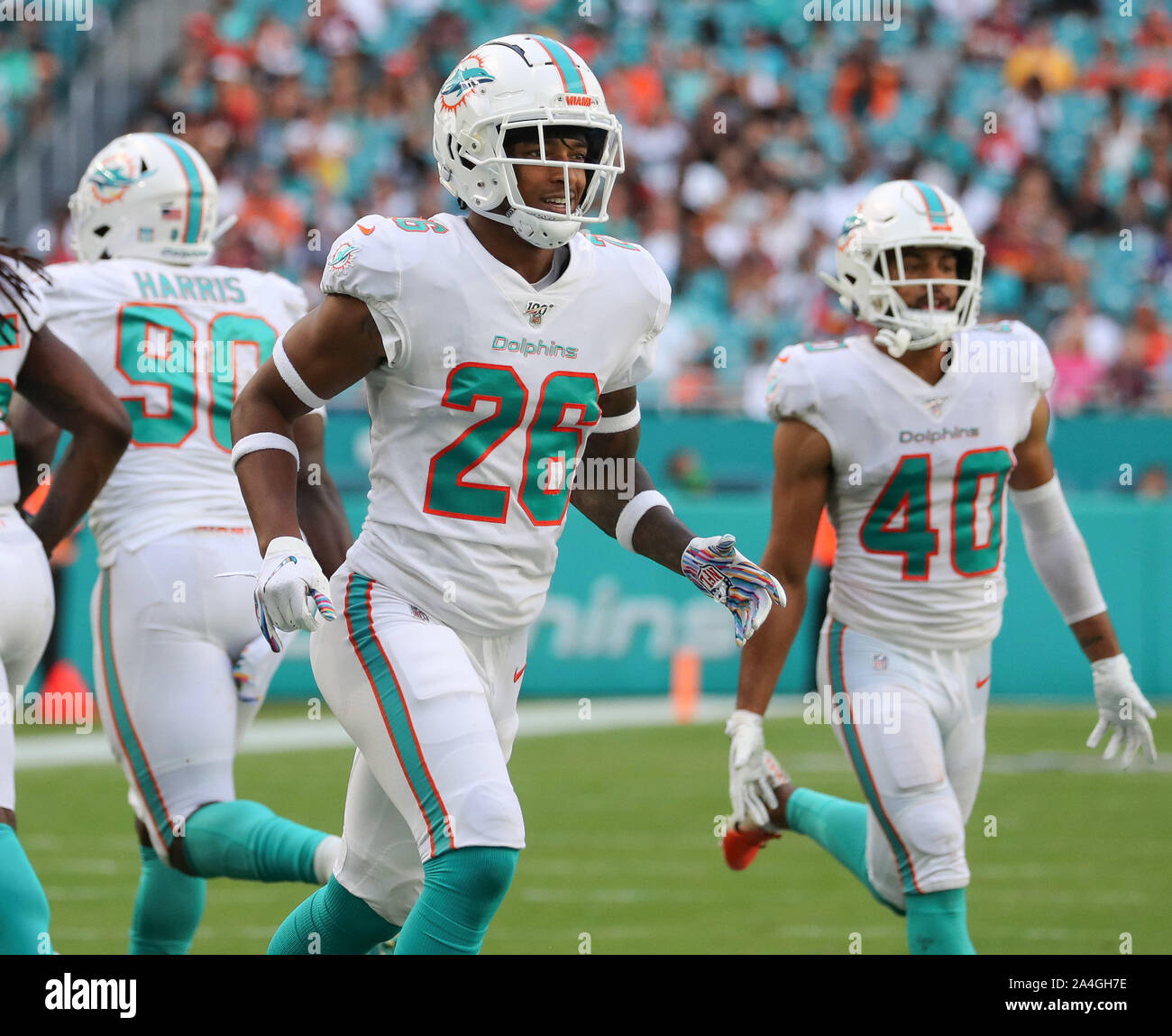 Miami Dolphins defensive back Steven Parker (26) signs his jersey, at the  end of an NFL